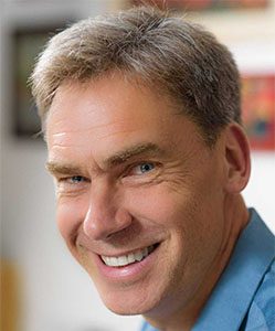 Headshot of Markus Brauer in a blue, collared shirt 