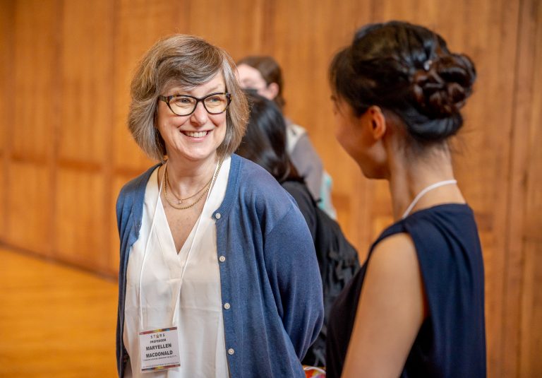 Professor Maryellen MacDonald speaking with a student at this year's Student Thesis and Research Symposium